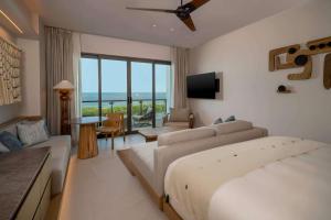 a hotel room with a bed and a living room at Grand Hyatt Cancun Beach Resort in Cancún