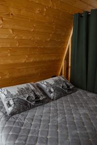 a bedroom with a bed in a wooden room at Zelemin House in Skole