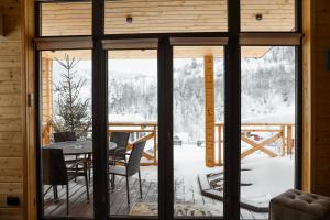 a room with a glass door and a table and chairs at Zelemin House in Skole