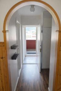 an archway leading into a hallway with a window at Eide Apartments Odda in Odda