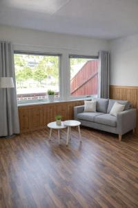a living room with a couch and a table at Eide Apartments Odda in Odda