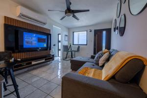a living room with a couch and a flat screen tv at Vista Serena in Salinas