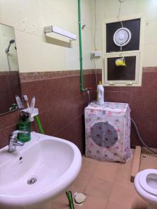 a bathroom with a sink and a toilet at Catchy & Traveler-Friendly Room in Dibba +11 photos
