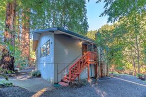 a tiny house in the woods with a staircase at Aunt Ginnys River View in Monte Rio