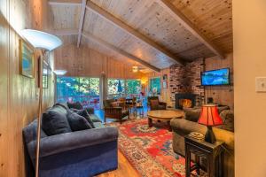 a living room with a couch and a table at Aunt Ginnys River View in Monte Rio