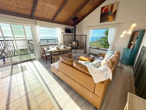 a living room with a couch and a table at Bella Oceana in Dillon Beach +10 photos