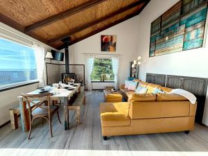 a living room with a couch and a table at Bella Oceana in Dillon Beach