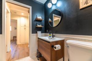 a bathroom with a sink and a mirror on the wall at Russian River Bungalow in Guerneville +33 photos