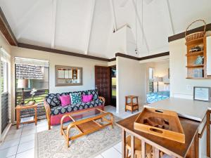 a living room with a couch and a table at #04 Black Sand Beach Condo in Pahala