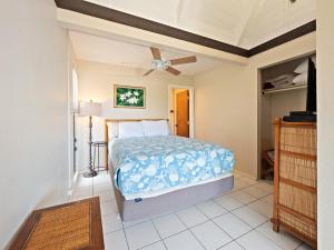 a bedroom with a bed and a ceiling fan at #04 Black Sand Beach Condo in Pahala
