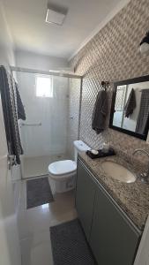 a bathroom with a toilet and a sink and a shower at Apartamento 3 quartos próximo à praia central de BC in Balneário Camboriú +22 photos