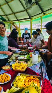 a group of people standing around a table full of food at Amazon Nativo Lodge in San Pedro +56 photos