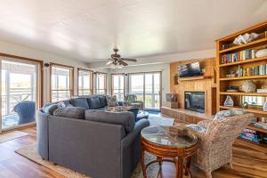 a living room with a couch and a tv at Looking Glass - Nags Head MP 12, Oceanfront, Ocean View, Pool, Hot Tub, Pets OK, Flex Stays in Nags Head