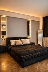 a bedroom with a large black bed in a room at V&G palma di montechiaro in Palma di Montechiaro +88 photos