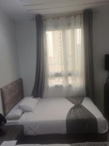 a bed sitting in a bedroom with a window at Capital Hotel in Downtown in Cairo