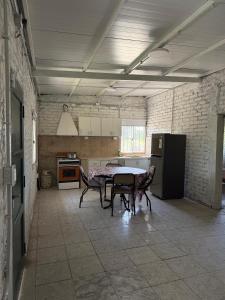 a kitchen with a table and chairs in a room at Viñedos del Este in San Juan