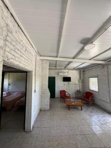 a room with red chairs and a bed in it at Viñedos del Este in San Juan