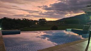 a swimming pool with a sunset in the background at Finca Hotel San Sebastian in La Paloma