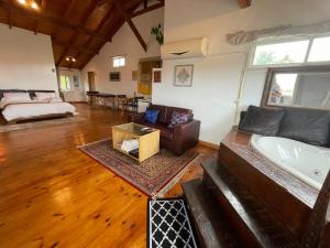 a living room with a tub and a bed at Nof Harim נוף הרים in Even Menahem