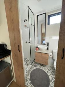 a bathroom with a shower and a toilet and a sink at Tiny Mountain River in Urubamba +34 photos