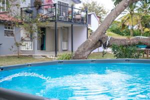 a large blue swimming pool in front of a house at Hidden Castle in Saint George