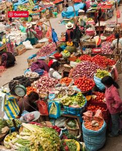 a market filled with lots of fruits and vegetables at Tiny Mountain River in Urubamba