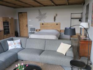 a living room with a couch and a bed at Hof van Kleeberg in Mechelen
