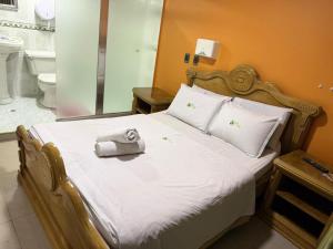 a bedroom with a bed with a towel on it at Hotel Bosque Chapinero in Bogotá