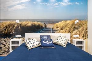 a blue table with pillows on the beach at Beachside Studio with Private Garden & Terrace 100m to the beach in Jūrmala +16 photos