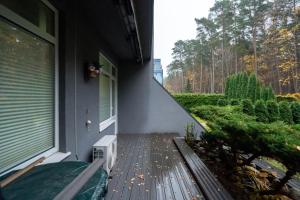 a porch of a house with a wooden deck at Beachside Studio with Private Garden & Terrace 100m to the beach in Jūrmala