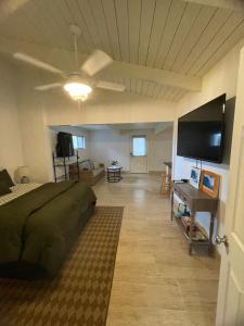 a bedroom with a bed and a flat screen tv at Hawaii Private Studio in Holualoa