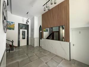 a hallway with white walls and a tile floor at Paseo Malecón Hab in Monforte de Lemos
