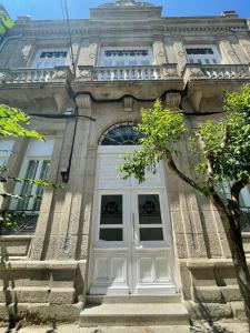a building with a white door in front of it at Paseo Malecón Hab in Monforte de Lemos