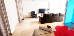 a living room with a couch and a teddy bear on a pillow at Atico Queen Itimad in San Juan de Aznalfarache