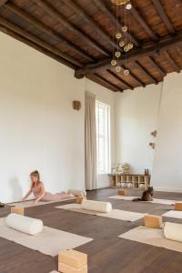 a woman performing a yoga pose in a room at Begijnhofpoort B&B in Turnhout