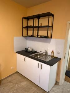 a kitchen with a sink and a mirror on the wall at Duren Bahnhof in Düren - Eifel +73 photos