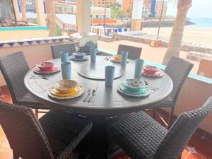 a table with plates and utensils on top of it at Las Gaviotas 2BR 2BA Ocean View 1st FL- 413 in Puerto Peñasco