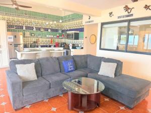 a living room with a couch and a table at Las Gaviotas 2BR 2BA Ocean View 1st FL- 413 in Puerto Peñasco