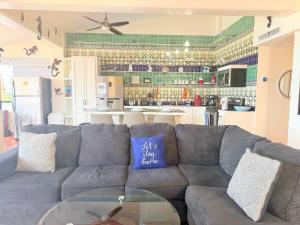 a living room with a couch and a glass table at Las Gaviotas 2BR 2BA Ocean View 1st FL- 413 in Puerto Peñasco