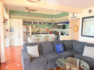a living room with a couch and a kitchen at Las Gaviotas 2BR 2BA Ocean View 1st FL- 413 in Puerto Peñasco +80 photos