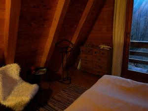 a bedroom with a bed and a dresser and a window at Twin Forest, riverside cabin in Brod na Kupi +30 photos