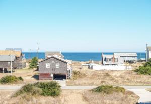 a group of houses on a hill near the ocean at Carolina Cottage - Kitty Hawk, Oceanside, Walk to Beach, Pool, Hot Tub, Pool Table in Kitty Hawk