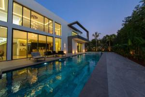 a house with a swimming pool in front of a house at Villa Royale Marrakech in Marrakesh