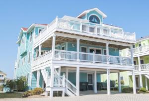 a large blue building with white balconies at Jockey's Ridge Haven - NH MP 13, Pool-Open Now for 2026, Cabana, Hot Tub, Pets OK, YR Flex Stays in Nags Head