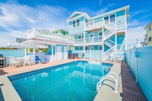 a house with a swimming pool in front of it at Jockey's Ridge Haven - NH MP 13, Pool-Open Now for 2026, Cabana, Hot Tub, Pets OK, YR Flex Stays in Nags Head