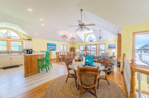 a kitchen and dining room with a table and chairs at Jockey's Ridge Haven - NH MP 13, Pool-Open Now for 2026, Cabana, Hot Tub, Pets OK, YR Flex Stays in Nags Head