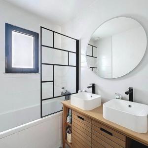 a bathroom with a sink and a mirror at La parenthèse basque in BIQ +4 photos