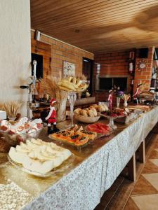 a buffet with many different types of food on a table at A Cabanha in Caçador