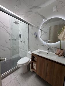a bathroom with a toilet and a shower and a sink at Casa Altavista in Pachuca de Soto +24 photos