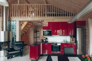 a kitchen with red cabinets and a chair in a room at Villa Stella in Äkäslompolo +30 photos